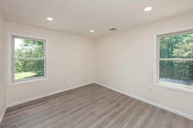 empty room with light hardwood / wood-style floors