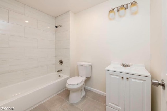 full bathroom with tile patterned flooring, vanity, tiled shower / bath combo, and toilet