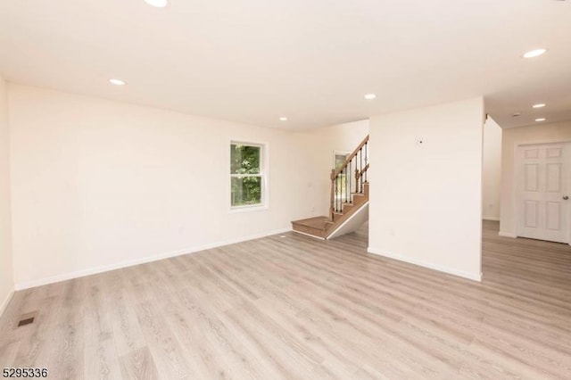 empty room with light hardwood / wood-style flooring