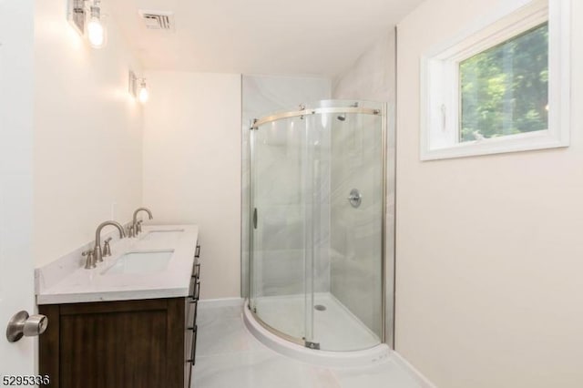 bathroom with vanity and a shower with door