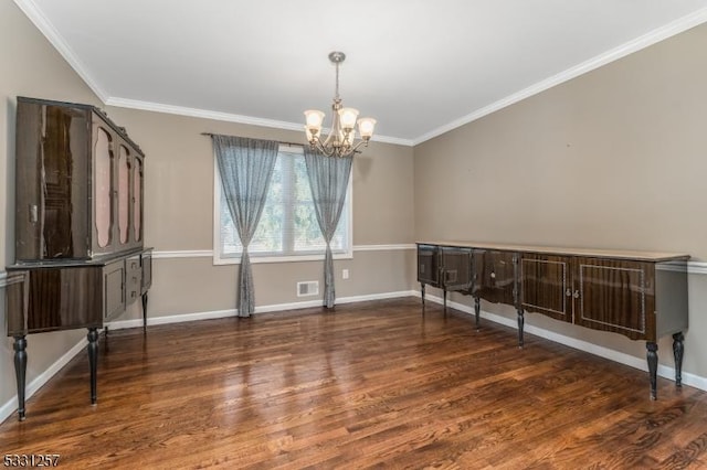 unfurnished room featuring dark hardwood / wood-style floors, an inviting chandelier, and ornamental molding