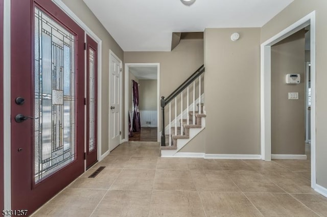 foyer featuring light tile patterned flooring