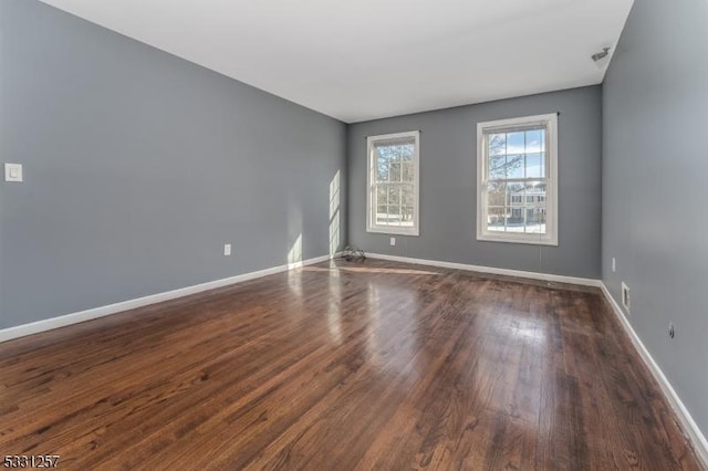 spare room featuring dark hardwood / wood-style floors