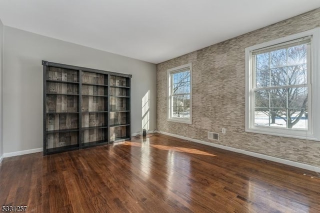 unfurnished room featuring dark wood-type flooring