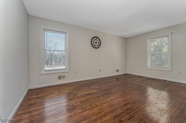 empty room featuring dark hardwood / wood-style flooring