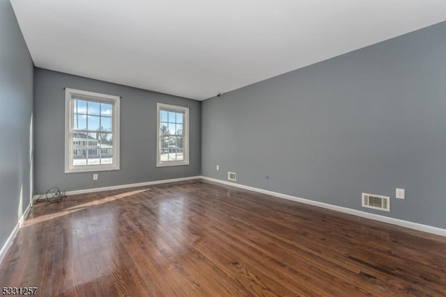 empty room with dark hardwood / wood-style floors