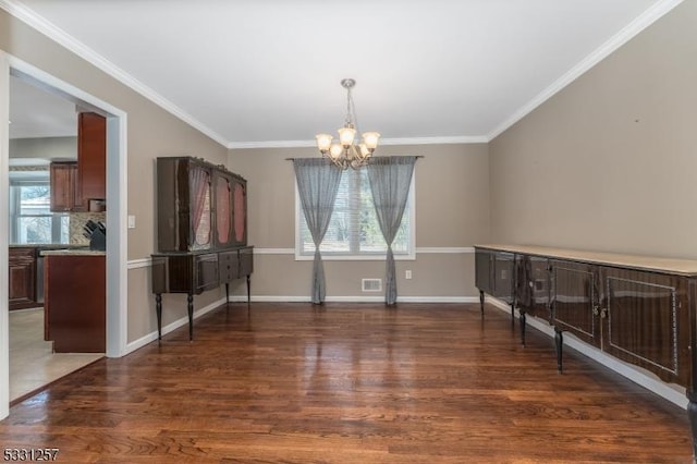 unfurnished dining area featuring a notable chandelier, dark hardwood / wood-style floors, and ornamental molding