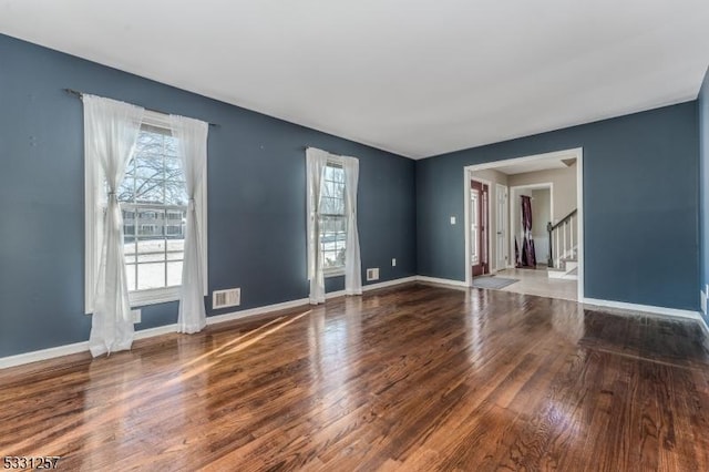 empty room with hardwood / wood-style flooring