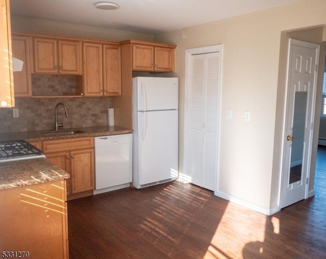 kitchen featuring white appliances, backsplash, dark hardwood / wood-style flooring, and sink