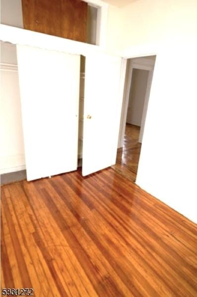 unfurnished bedroom with hardwood / wood-style flooring