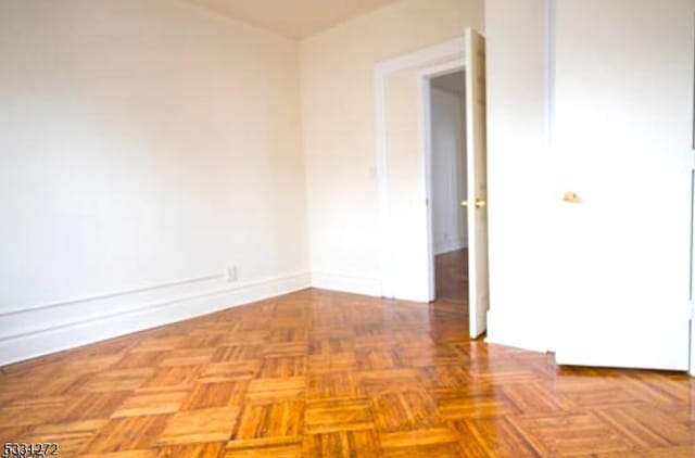 unfurnished room featuring light parquet floors