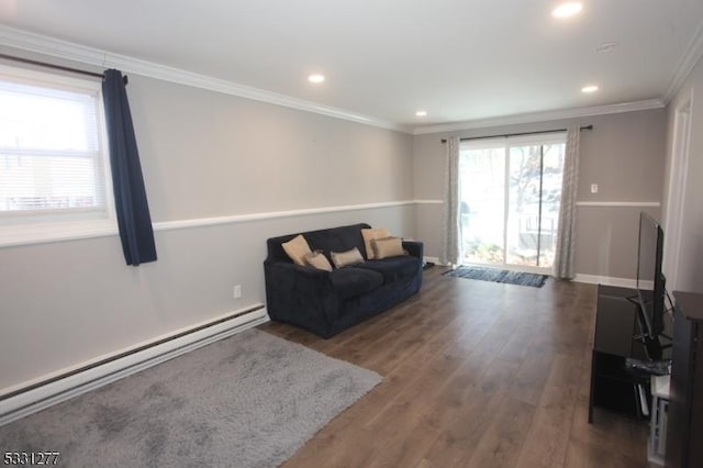 sitting room featuring baseboard heating, dark wood-type flooring, and crown molding