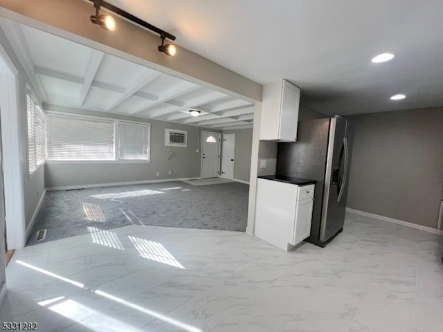 kitchen with white cabinets, vaulted ceiling with beams, and stainless steel refrigerator with ice dispenser