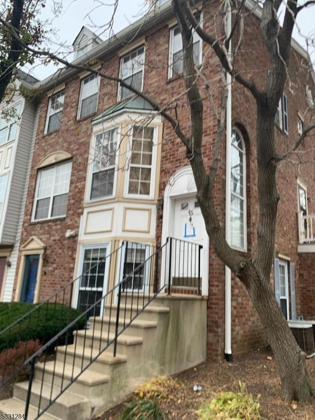 view of front facade featuring central AC