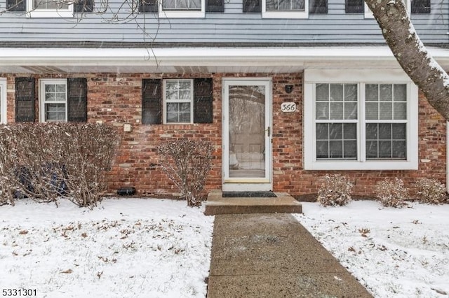 view of snow covered property entrance