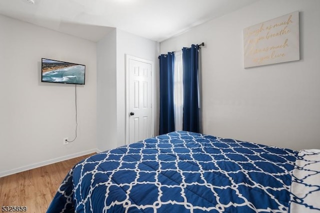 bedroom with wood-type flooring