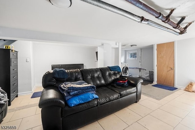 living room featuring light tile patterned floors and washer / dryer