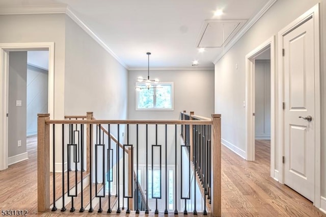 hall with light wood-type flooring and crown molding