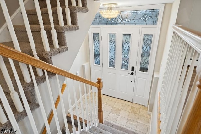 tiled foyer with a notable chandelier