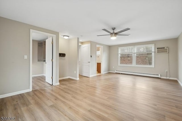 interior space with light wood-type flooring, ceiling fan, an AC wall unit, and a baseboard radiator