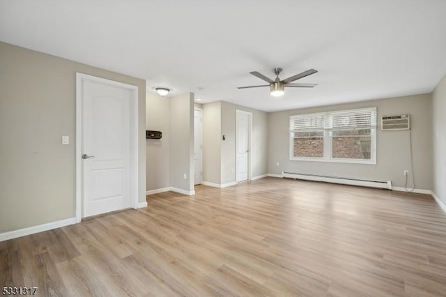 empty room featuring an AC wall unit, a baseboard radiator, ceiling fan, and light wood-type flooring