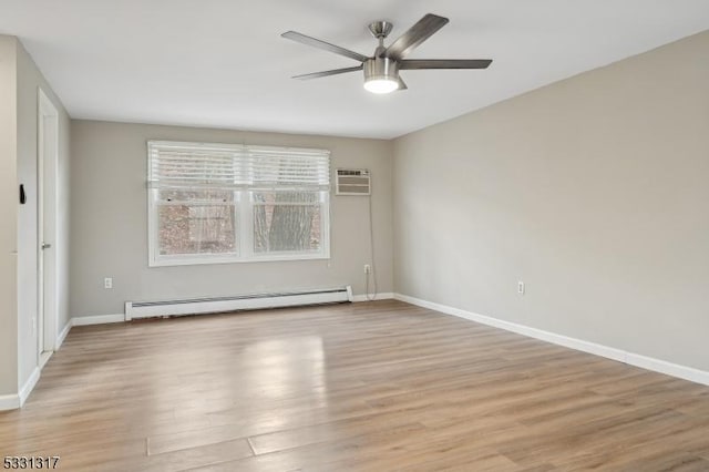 spare room with ceiling fan, baseboard heating, an AC wall unit, and light wood-type flooring