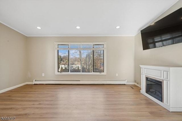 unfurnished living room with baseboard heating, light hardwood / wood-style flooring, and crown molding