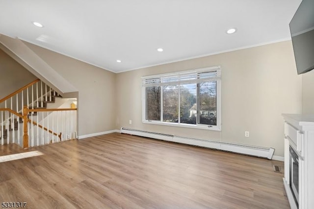 unfurnished living room featuring baseboard heating, ornamental molding, and light hardwood / wood-style floors