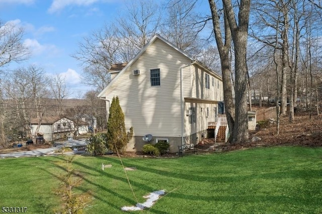 view of side of home featuring a lawn