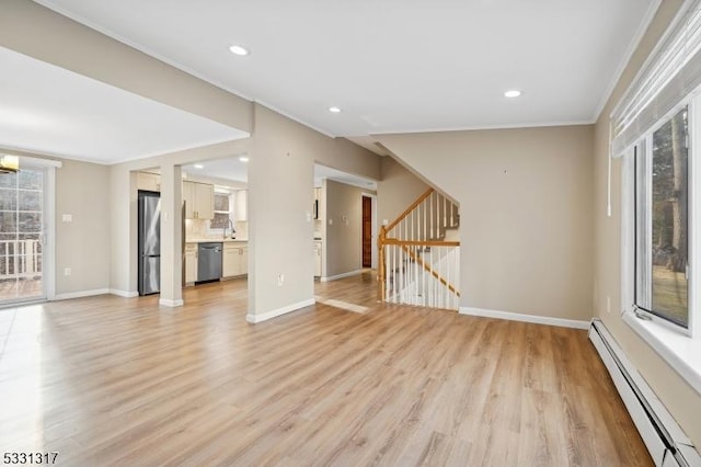 unfurnished living room with light hardwood / wood-style floors, sink, ornamental molding, and a baseboard radiator