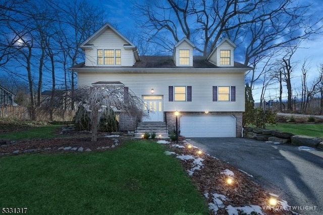 view of front facade featuring a front yard and a garage