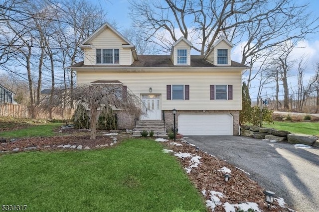 view of front of house featuring a front lawn and a garage