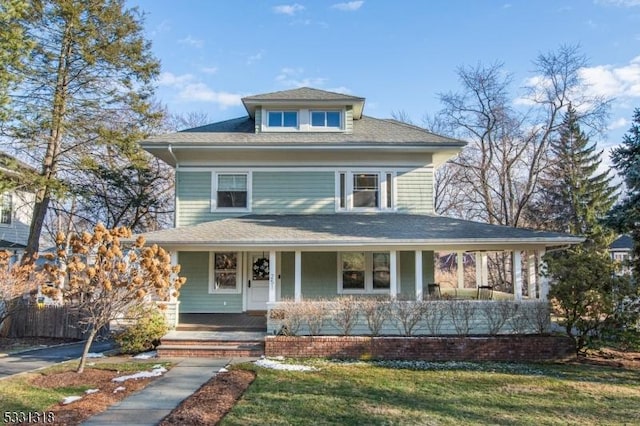 view of front of house with covered porch and a front yard