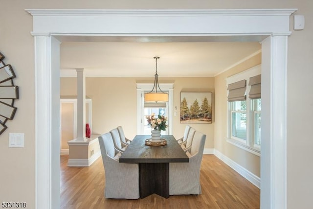 dining area with hardwood / wood-style floors and ornamental molding