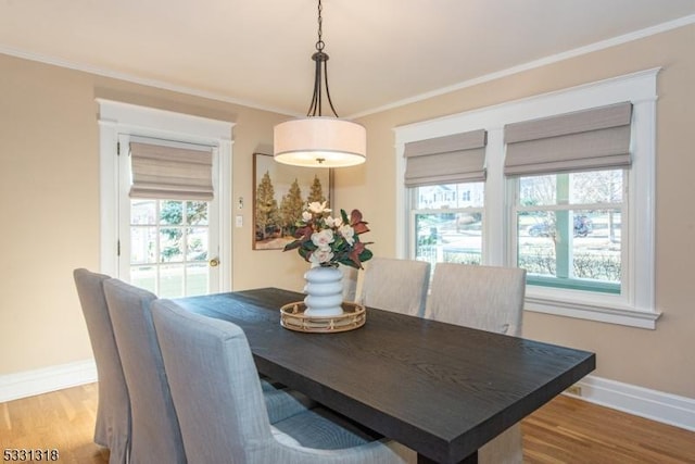 dining room with hardwood / wood-style floors and ornamental molding