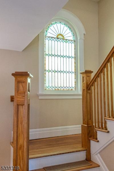 stairs with hardwood / wood-style floors