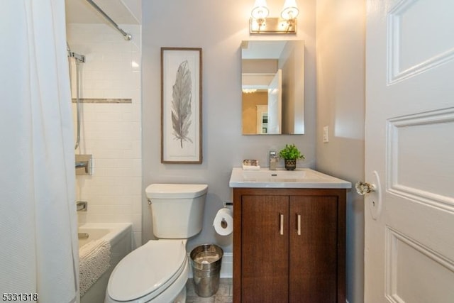 full bathroom featuring vanity, tiled shower / bath combo, and toilet