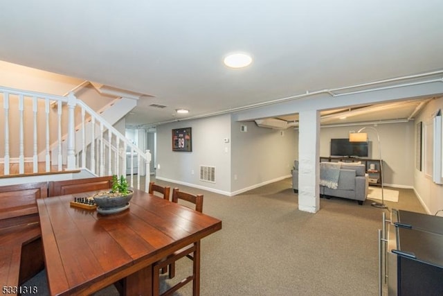 dining room with carpet floors and a wall mounted AC