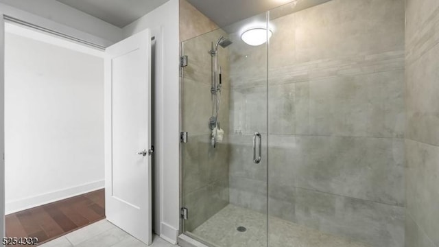 bathroom featuring tile patterned flooring and an enclosed shower