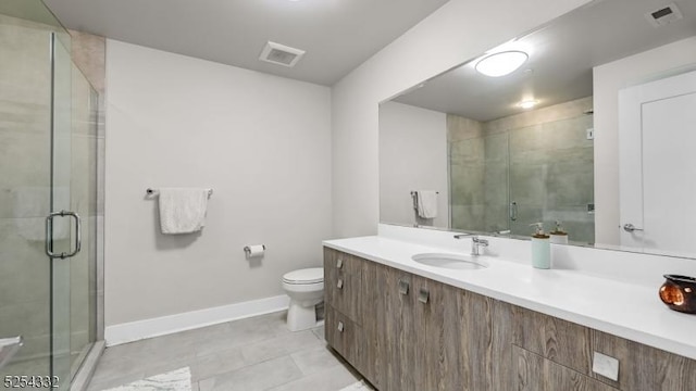 bathroom with vanity, toilet, and a shower with shower door