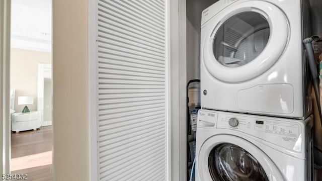 laundry room with stacked washing maching and dryer