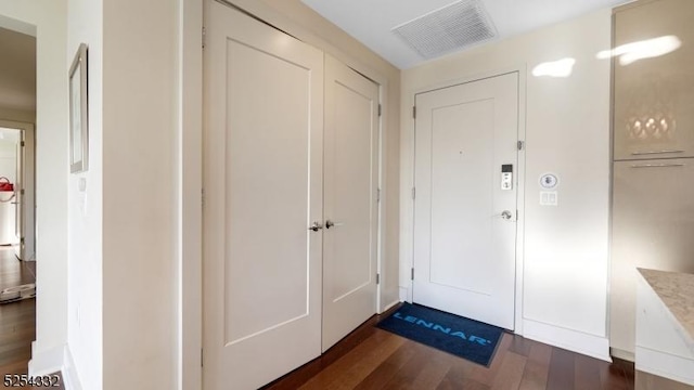 doorway with dark wood-type flooring