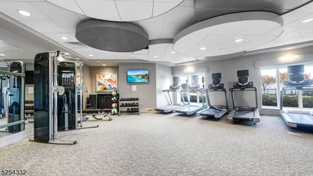 gym featuring a paneled ceiling and carpet floors