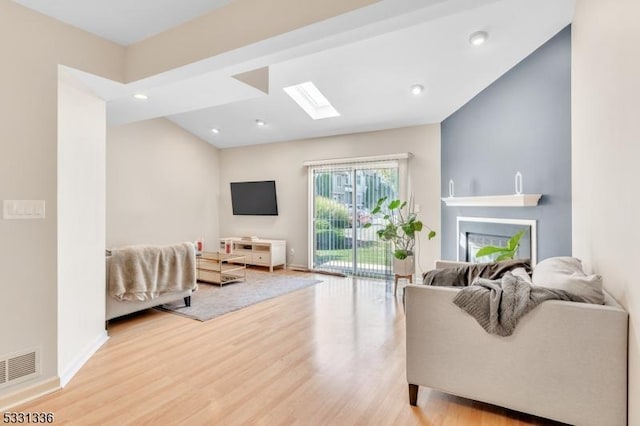 living room featuring light hardwood / wood-style floors and a fireplace