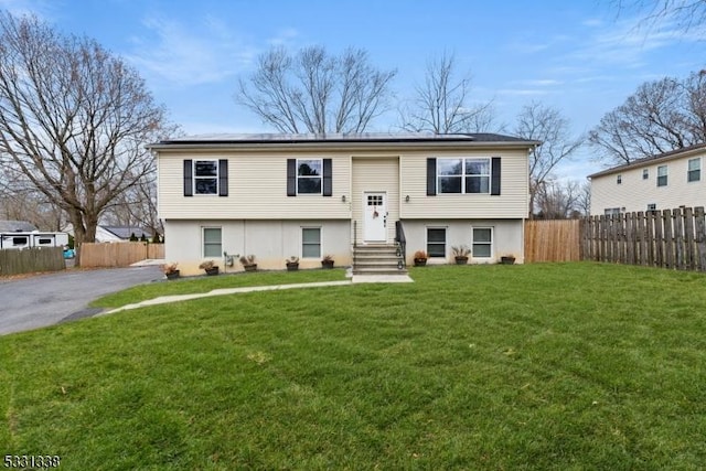 raised ranch featuring a front yard