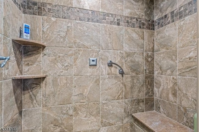 bathroom with a tile shower