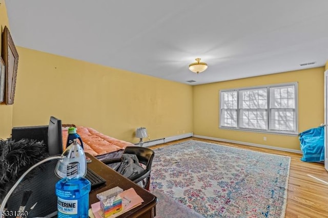 living area featuring light hardwood / wood-style flooring and a baseboard radiator