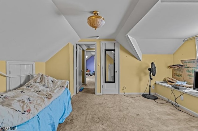 bedroom with carpet floors and vaulted ceiling