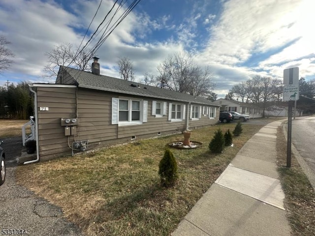 view of home's exterior with a lawn