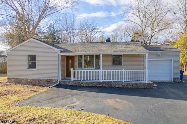 ranch-style home with a garage and covered porch